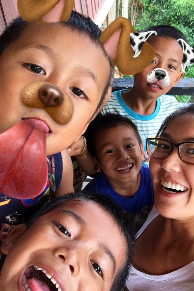 Laotian kids playing with Snapchat